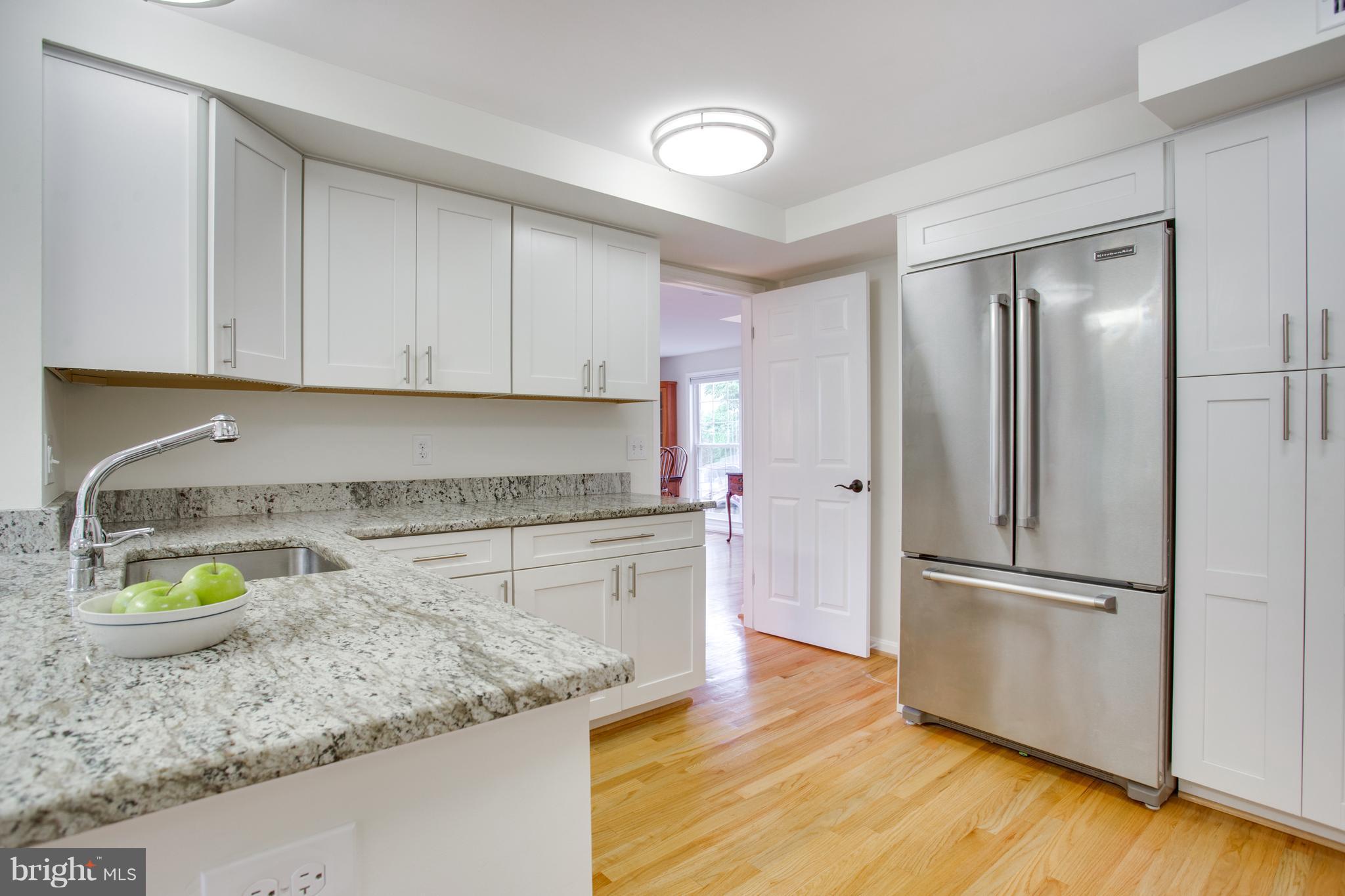 1511 Deer Point Way Reston, VA 20194 - Photo 5 of 30 a kitchen with a refrigerator sink and stove