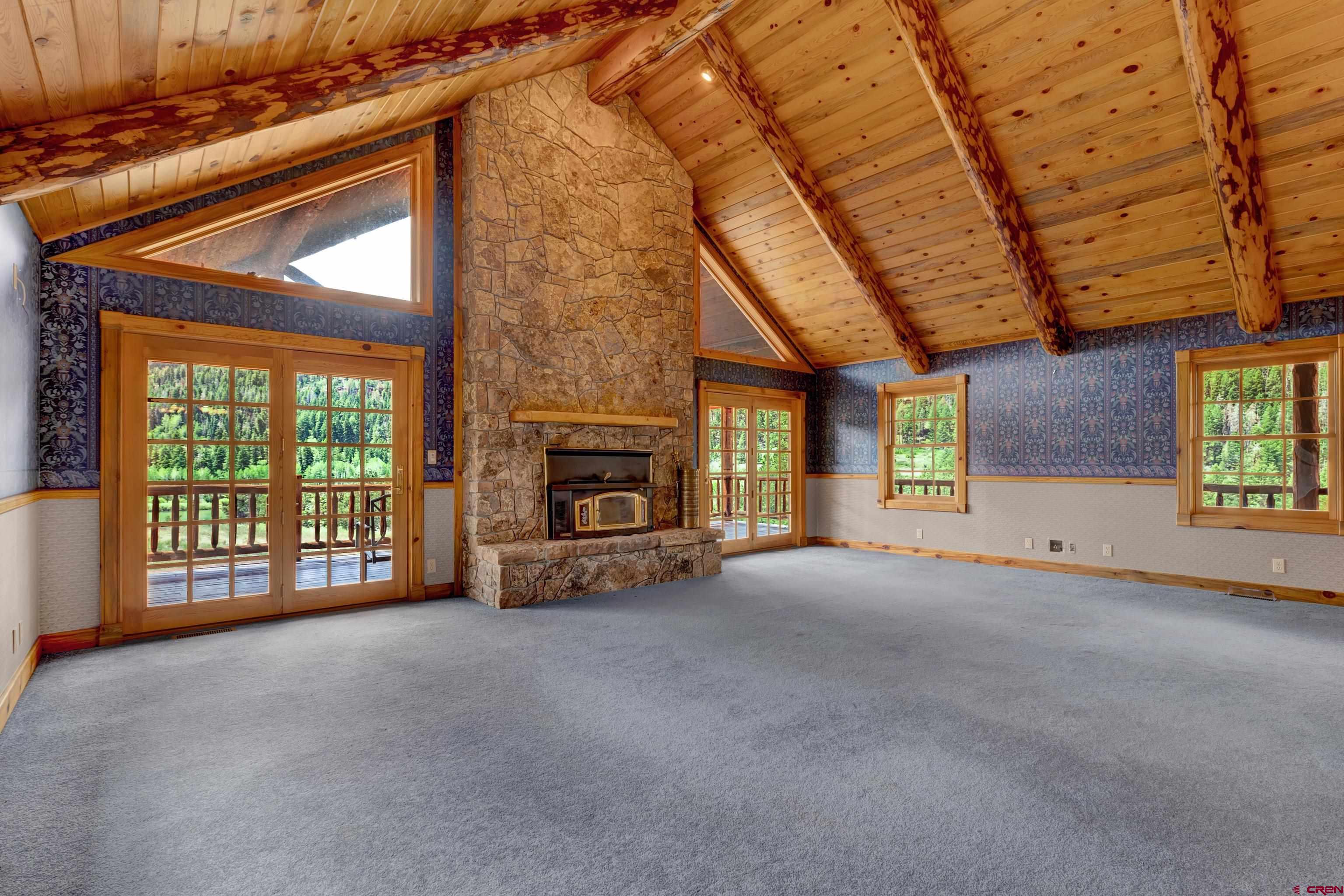 2692 County Road 17 Ridgway, CO 81432 - Photo 14 of 38 a view of a livingroom with a fireplace and a window