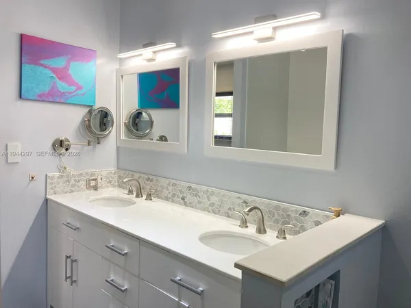 a bathroom with a double vanity sink and a mirror
