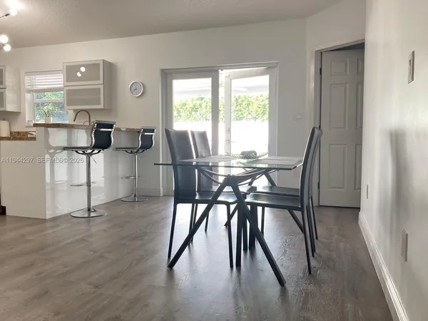 a view of a dining room with furniture and a large window
