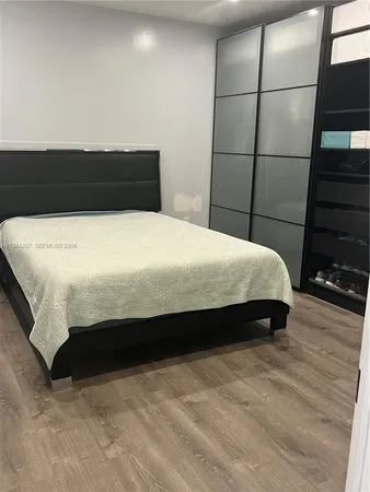 a bedroom with a bed and a night stand