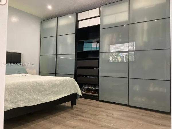 a bedroom with a bed and a walk in closet