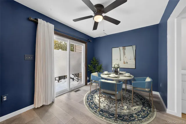 an empty room with fan and windows