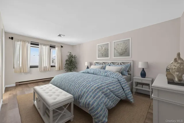 a view of an empty room with wooden floor and window