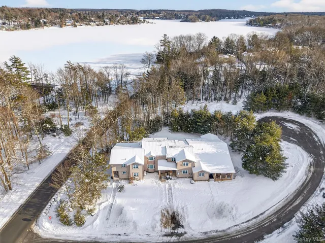 a view of a house with a yard and lake view