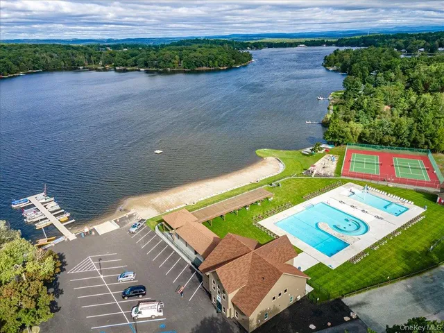 a view of swimming pool with an outdoor seating a yard and lake view