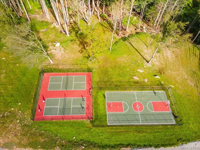 a view of a tennis court with a couch and wooden floor