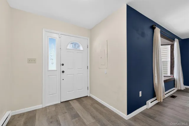 a view of entryway with wooden floor