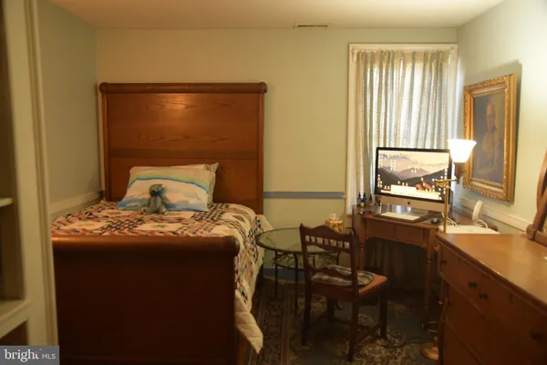 a bedroom with a bed and a table in it