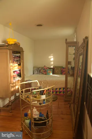 a room with water heater and wooden cabinets