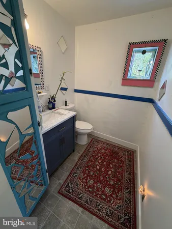 a bathroom with a toilet a sink and mirror