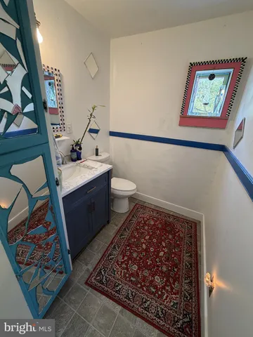 a bathroom with a toilet a sink and mirror