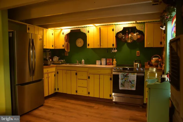 a kitchen with a refrigerator and a stove