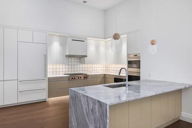 a kitchen with granite countertop a sink and cabinets