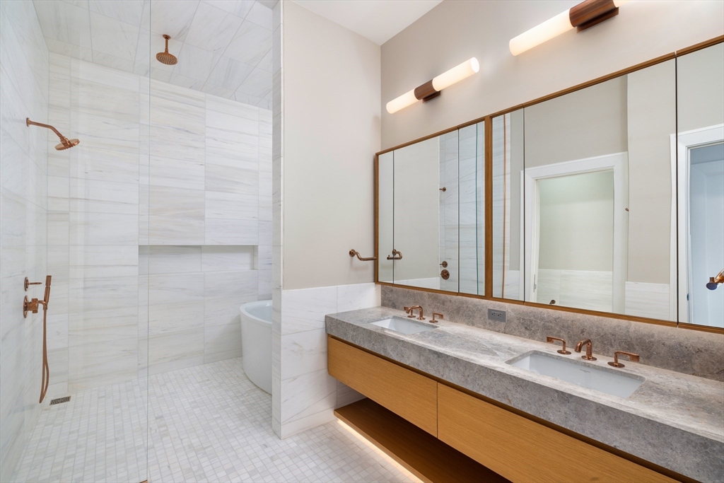 45 Temple Street, Unit 306 Boston, MA 02114 - Photo 6 of 13 a bathroom with a double vanity sink and a mirror
