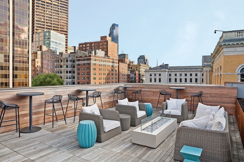 45 Temple Street, Unit 306 Boston, MA 02114 - Photo 7 of 13 a roof deck with couches and wooden floor