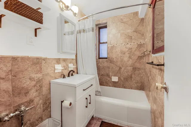 a bathroom with a sink mirror toilet and bathtub