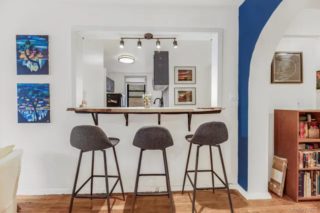 a table chair and a lamp on a table with wooden floor