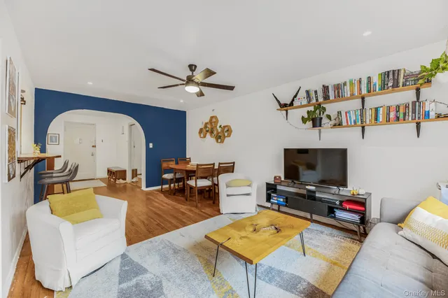a living room with furniture a rug and a flat screen tv