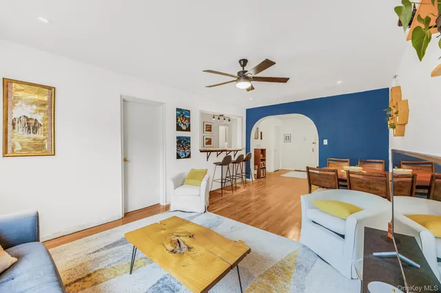 a living room with furniture a rug and a chandelier