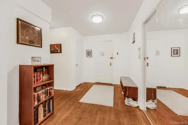 a living room with couch and a wooden floor