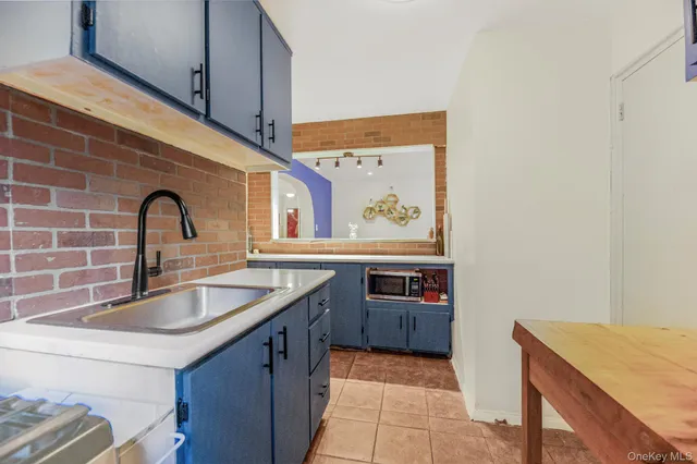 a kitchen with stainless steel appliances granite countertop a sink and a microwave