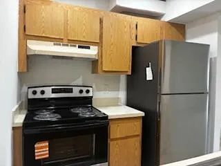 a stove top oven sitting inside of a kitchen