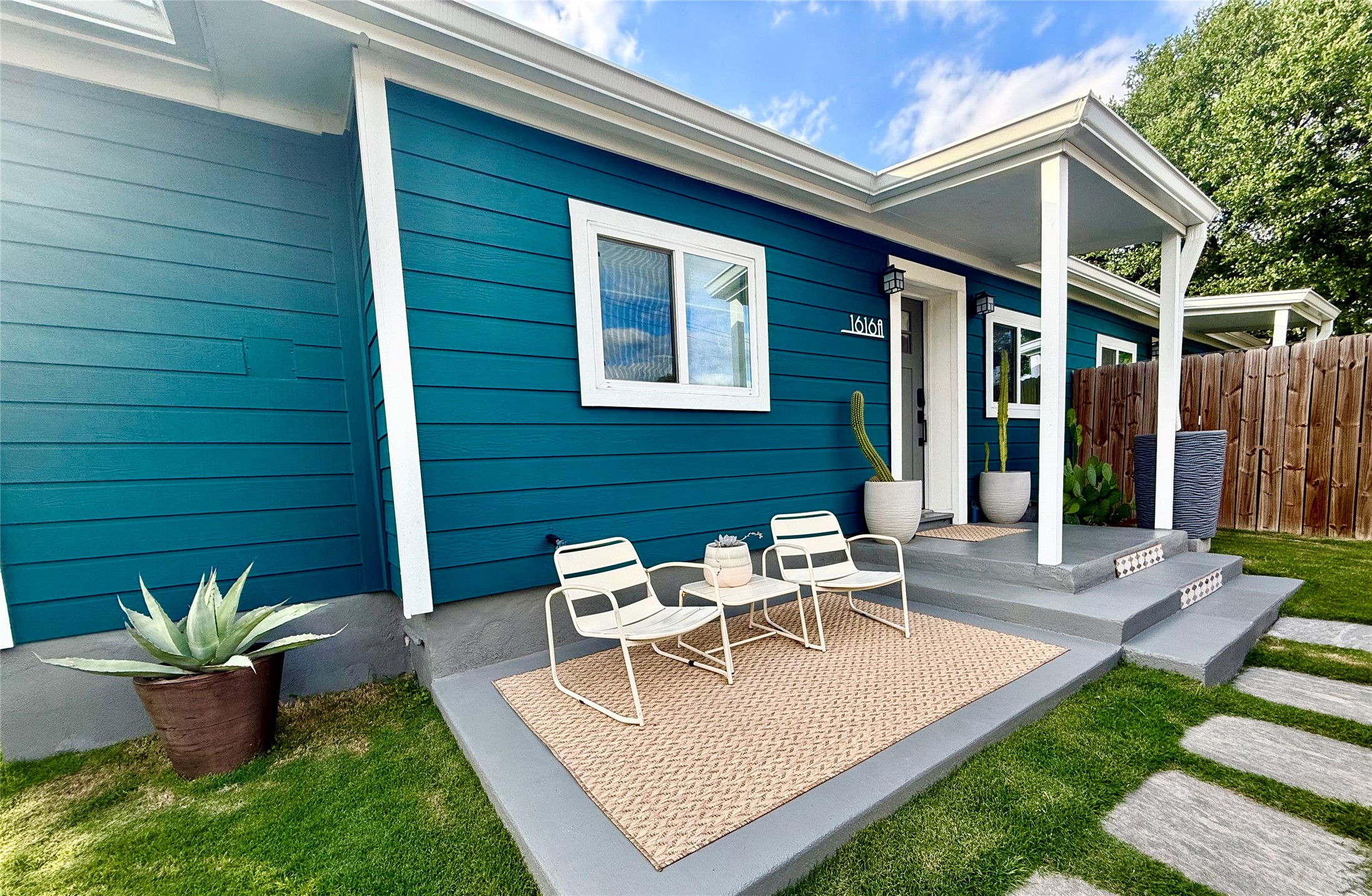 1616 Webberville Road, Unit A Austin, TX 78721 - Photo 1 of 35 Teal horizontal siding exterior with white trim accents
