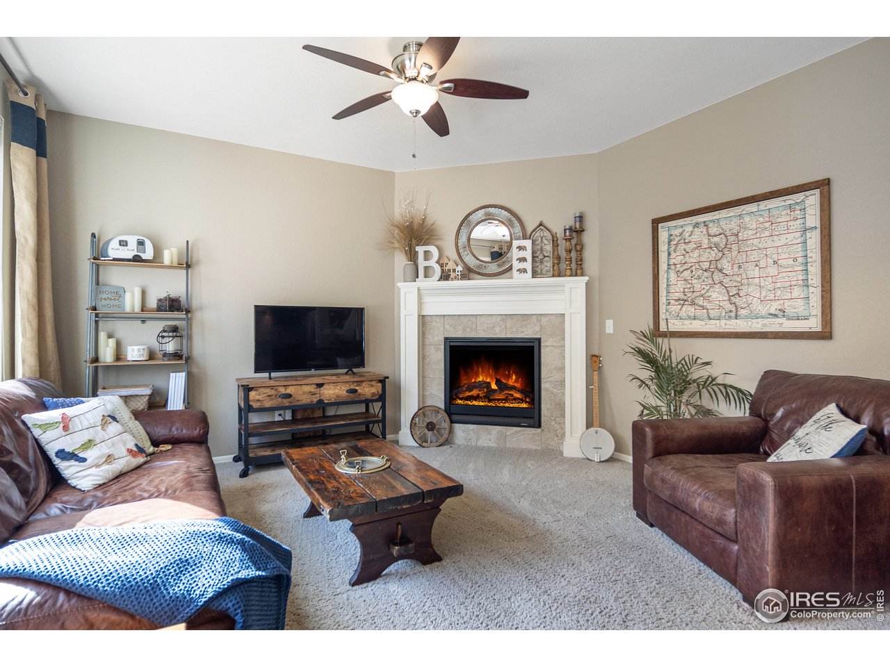 2139 Blue Yonder Way Fort Collins, CO 80525 - Photo 20 of 37 a living room with furniture a flat screen tv and a fireplace