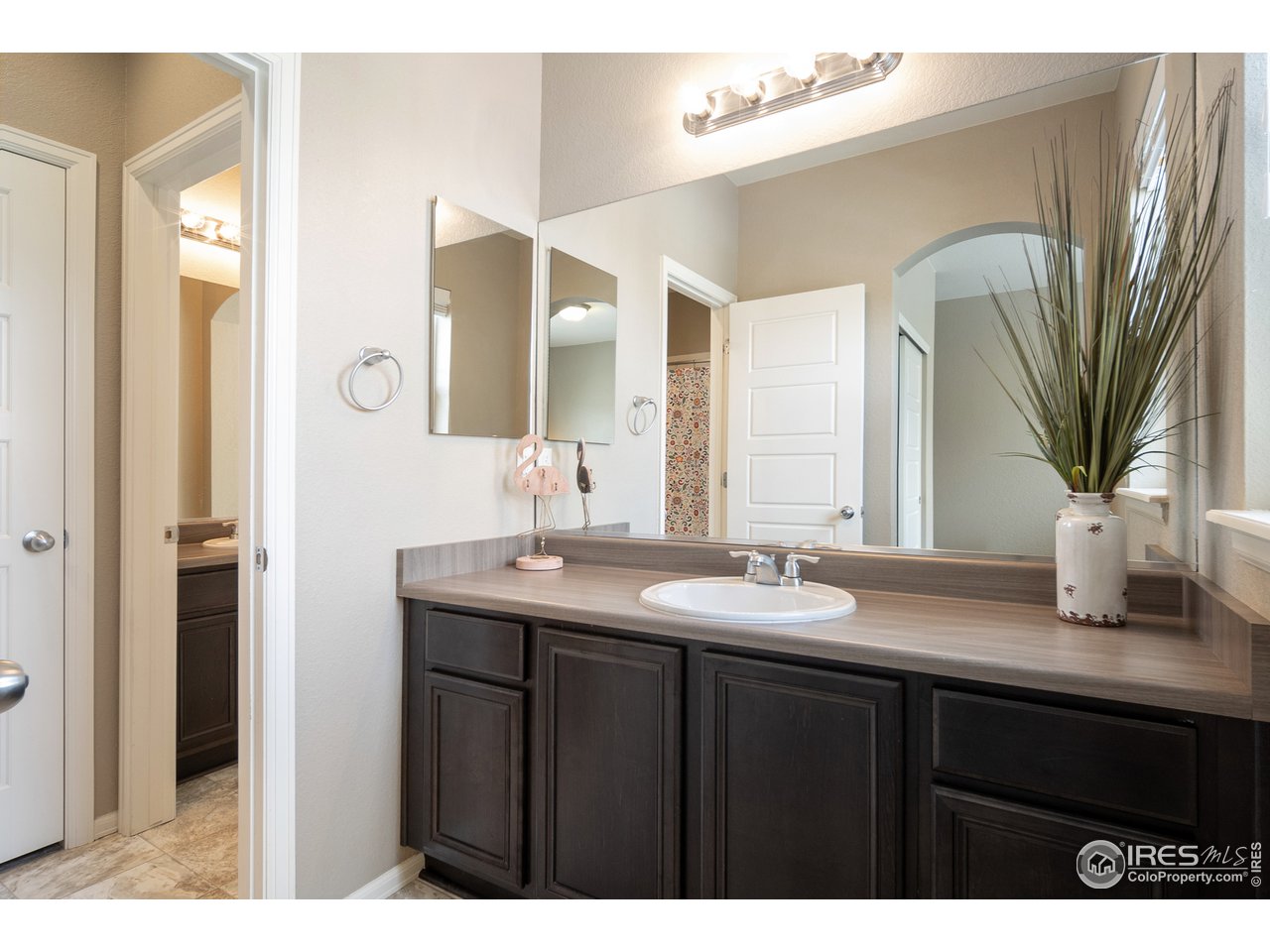 2139 Blue Yonder Way Fort Collins, CO 80525 - Photo 25 of 37 a bathroom with a granite countertop sink a mirror and a vanity