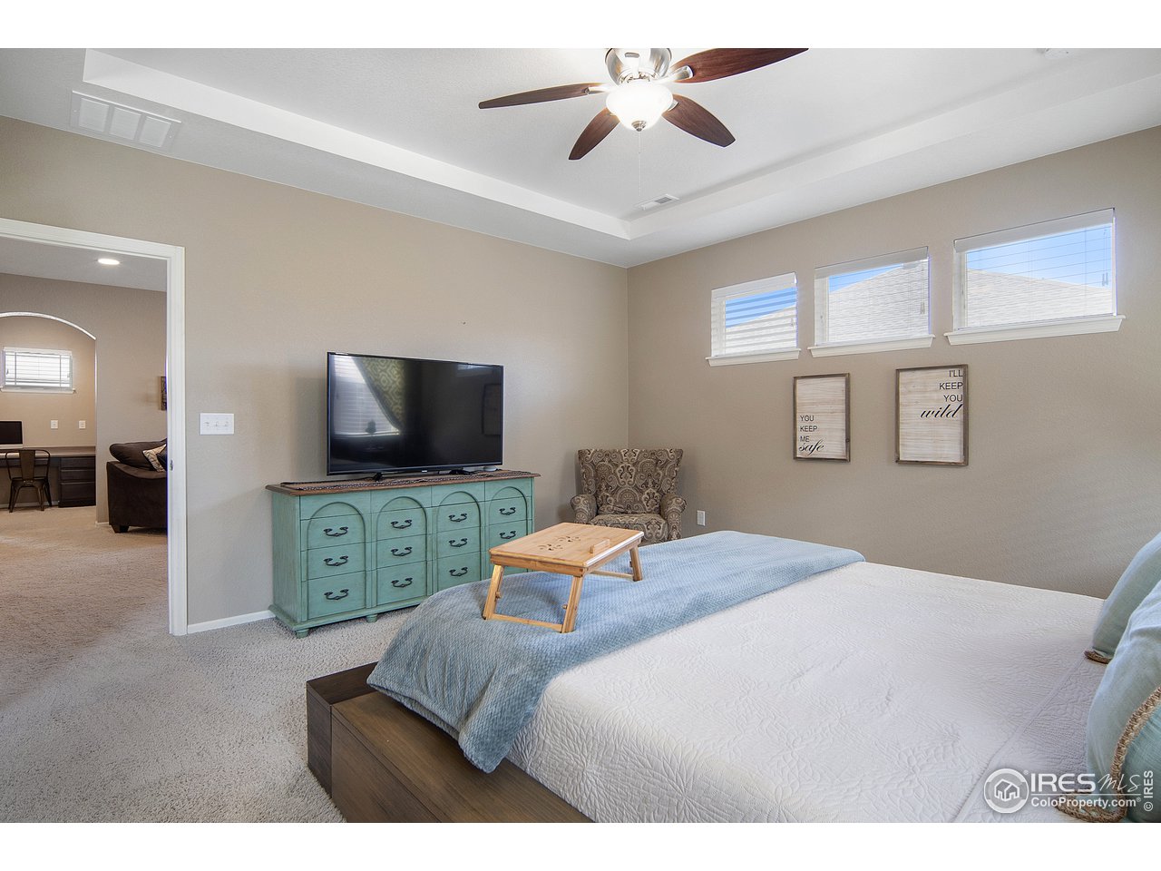 2139 Blue Yonder Way Fort Collins, CO 80525 - Photo 28 of 37 a bedroom with a bed and a flat screen tv