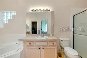4325 Wordsworth Way Venice, FL 34293 - Photo 13 of 24 a bathroom with a sink a toilet and a mirror
