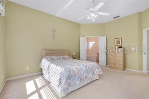 4325 Wordsworth Way Venice, FL 34293 - Photo 15 of 24 a bedroom with a bed and a chandelier