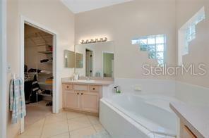 4325 Wordsworth Way Venice, FL 34293 - Photo 19 of 24 a bathroom with a bathtub a double vanity sink and mirror