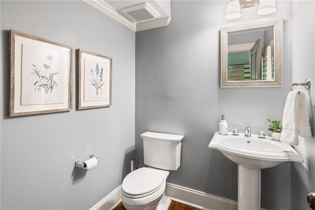 6645 Will Allen Road Cumming, GA 30040 - Photo 26 of 62 a bathroom with a toilet sink and mirror