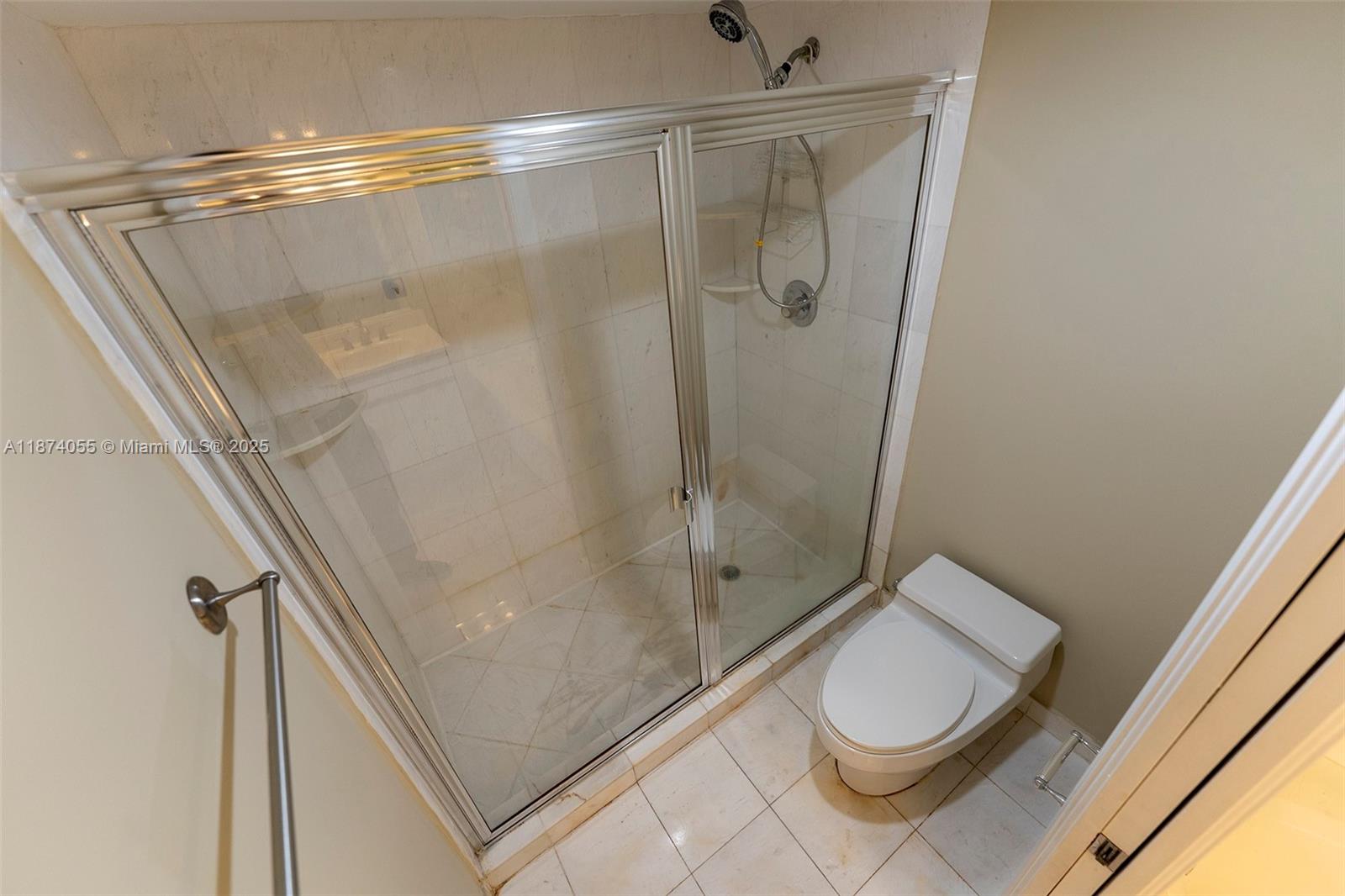 3530 Mystic Pointe Drive, Unit 2207 Aventura, FL 33180 - Photo 13 of 26 a bathroom with a shower a toilet and sink