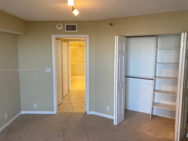 a view of an empty room with a closet