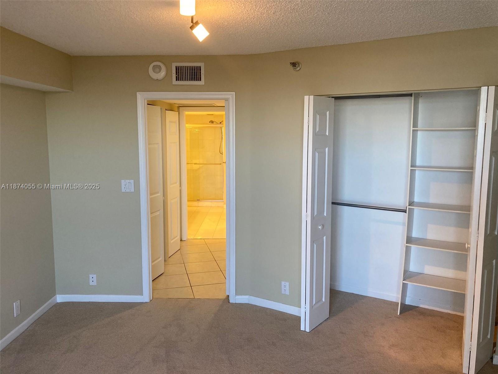 3530 Mystic Pointe Drive, Unit 2207 Aventura, FL 33180 - Photo 16 of 26 a view of an empty room with a closet