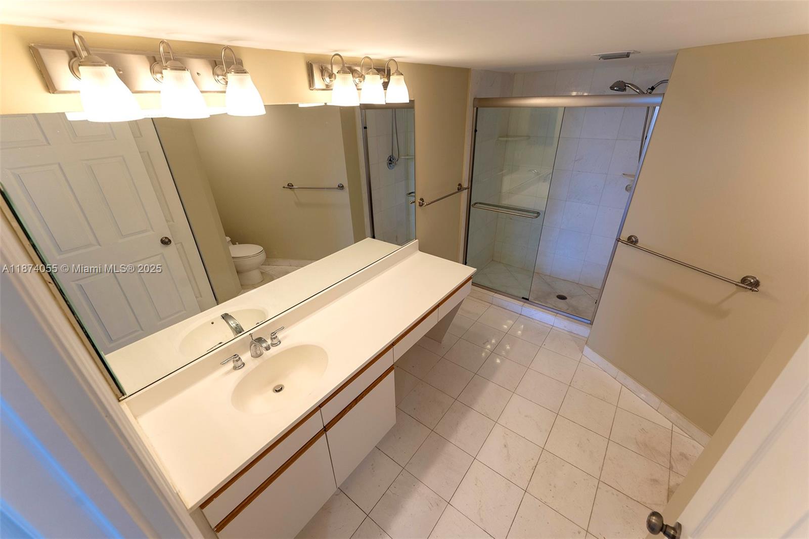 3530 Mystic Pointe Drive, Unit 2207 Aventura, FL 33180 - Photo 17 of 26 a bathroom with a sink and mirror