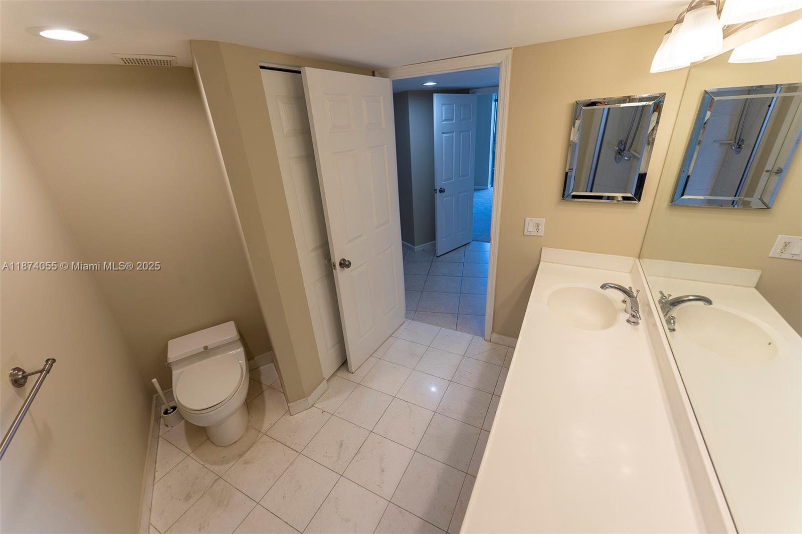 3530 Mystic Pointe Drive, Unit 2207 Aventura, FL 33180 - Photo 18 of 26 a bathroom with a sink and toilet