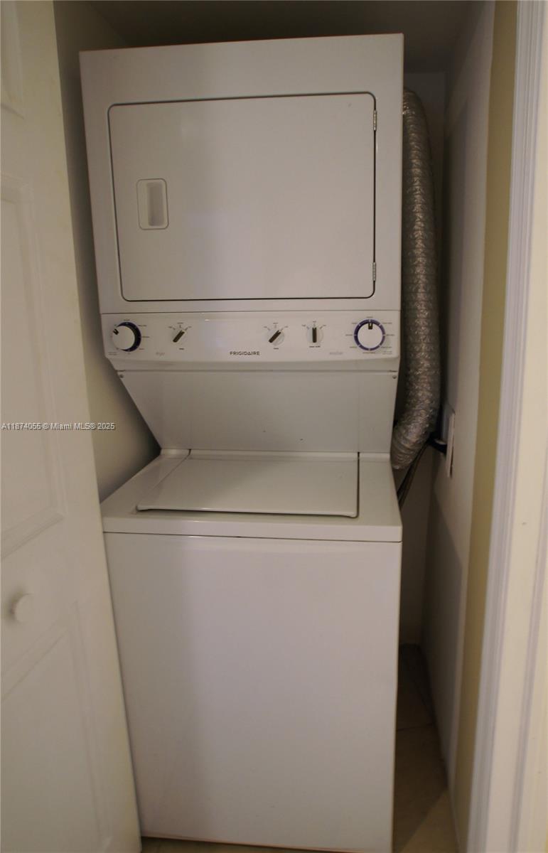 3530 Mystic Pointe Drive, Unit 2207 Aventura, FL 33180 - Photo 19 of 26 a utility room with dryer and washer