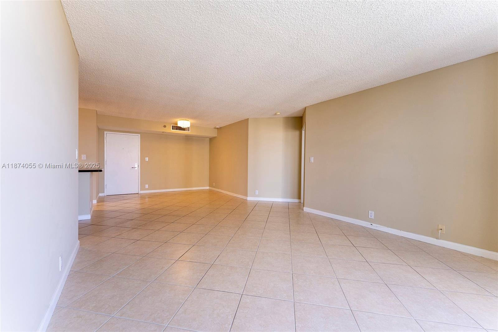 3530 Mystic Pointe Drive, Unit 2207 Aventura, FL 33180 - Photo 3 of 26 a view of an empty room and a window