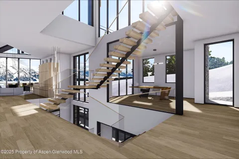 a living room with furniture and stairs