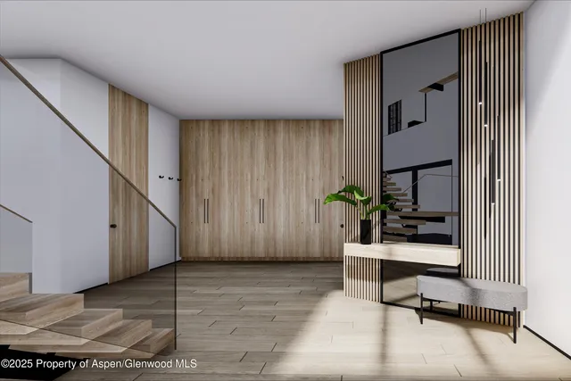 a view of an entryway with wooden floor