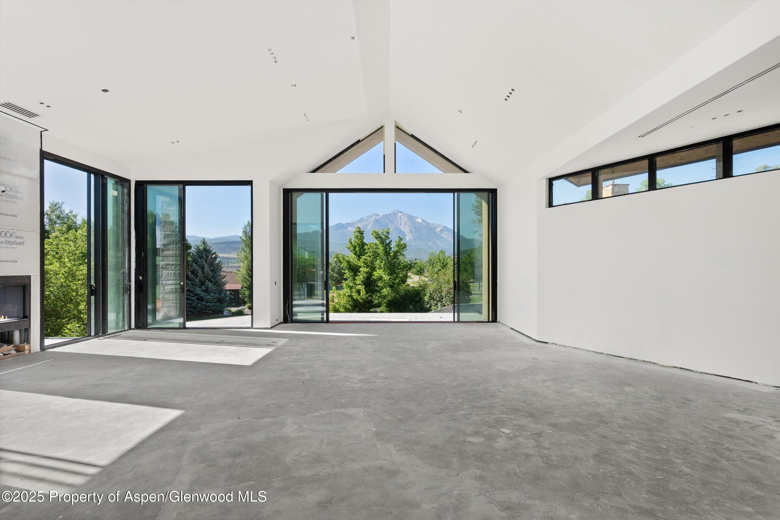 769 Perry Ridge Carbondale, CO 81623 - Photo 3 of 36 a view of a room with large windows and a rug