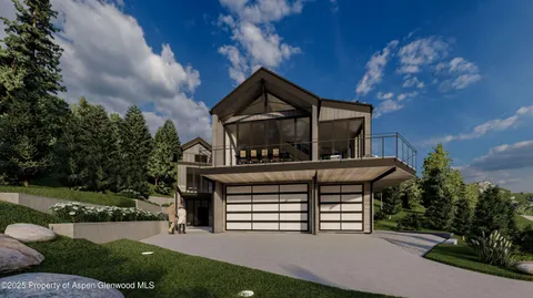 a view of a house with a small yard plants and a large tree