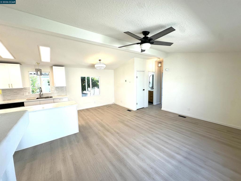 60 Wilson Way Milpitas, CA 95035 - Photo 2 of 22 a view of an empty room and window with wooden floor