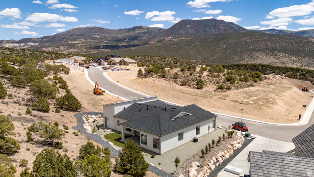 2862 South Mountain Rnch Road Cedar City, UT 84720 - Photo 62 of 64 Modern residence with a dark shingle roof and light-colored siding, featuring a covered entry porch