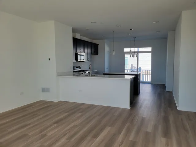 a view of a kitchen with a sink and a window
