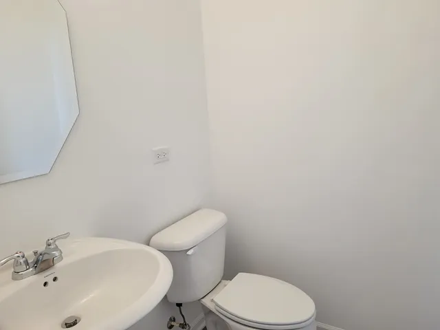 a white toilet sitting next to a white sink